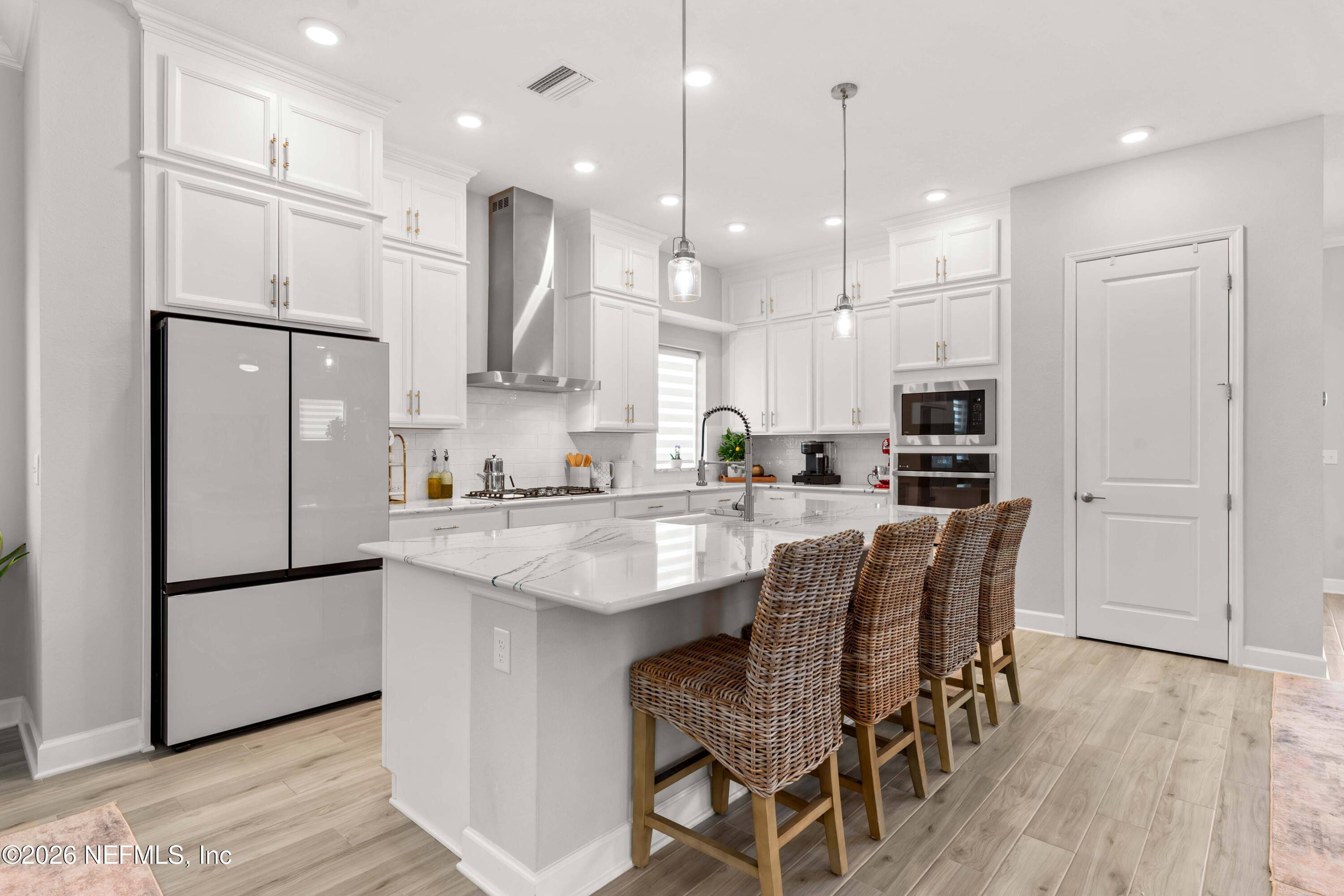 5270 Piney Flats Road Jacksonville, FL 32224 - Photo 15 of 53 a kitchen with stainless steel appliances granite countertop a refrigerator a sink dishwasher a stove and a refrigerator with wooden floor