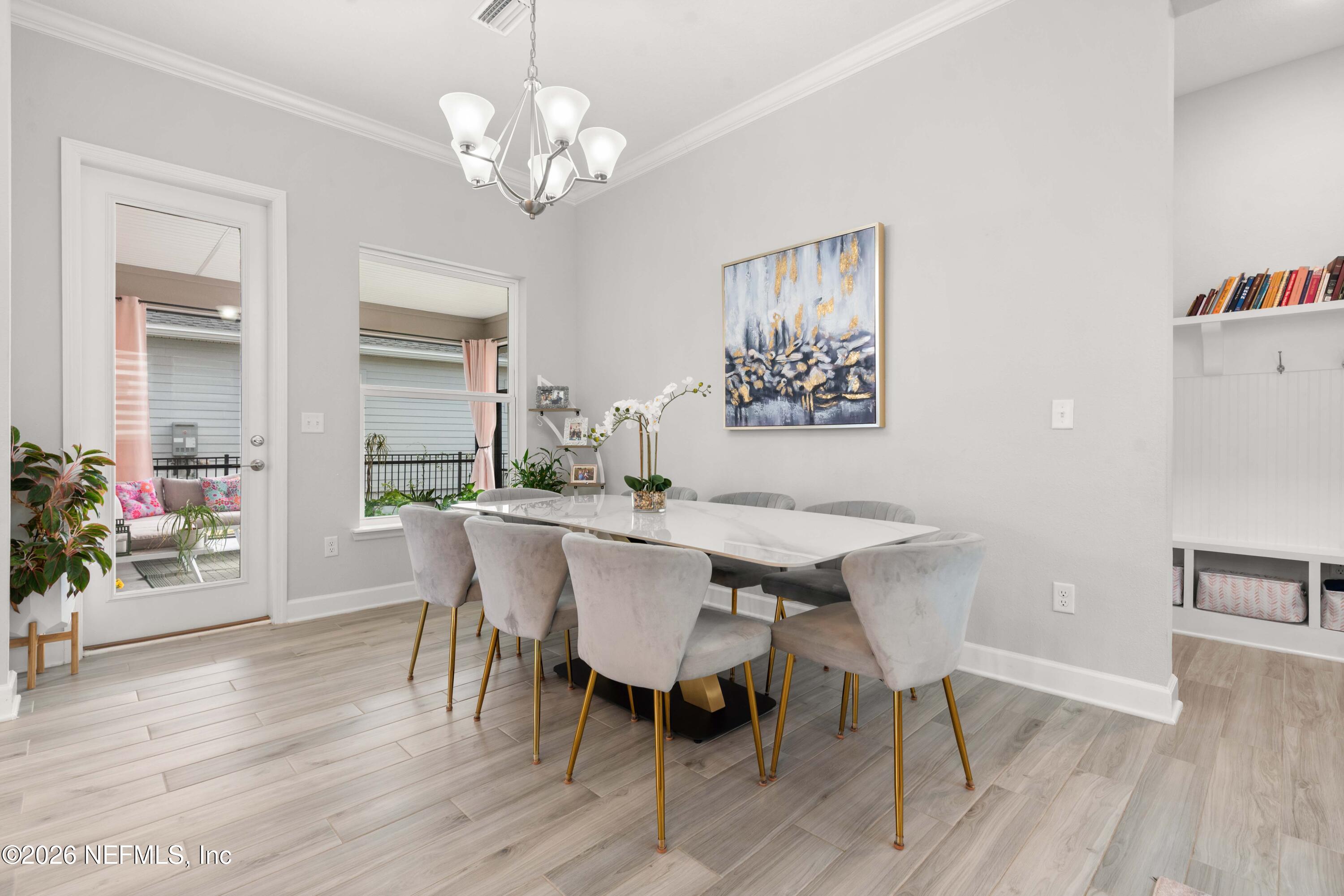 5270 Piney Flats Road Jacksonville, FL 32224 - Photo 20 of 53 a view of a dining room with furniture wooden floor and a chandelier