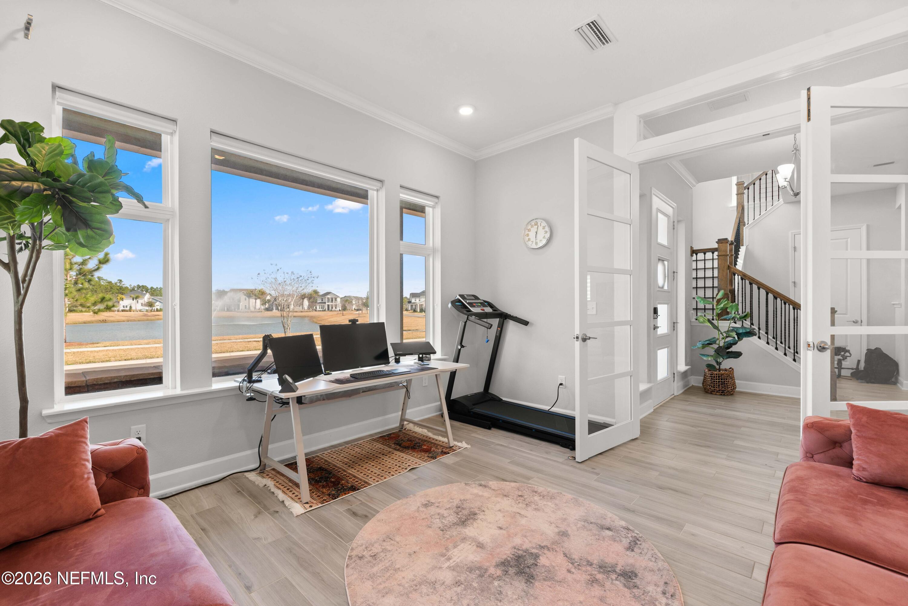 5270 Piney Flats Road Jacksonville, FL 32224 - Photo 21 of 53 a living room with furniture floor to ceiling window and wooden floor