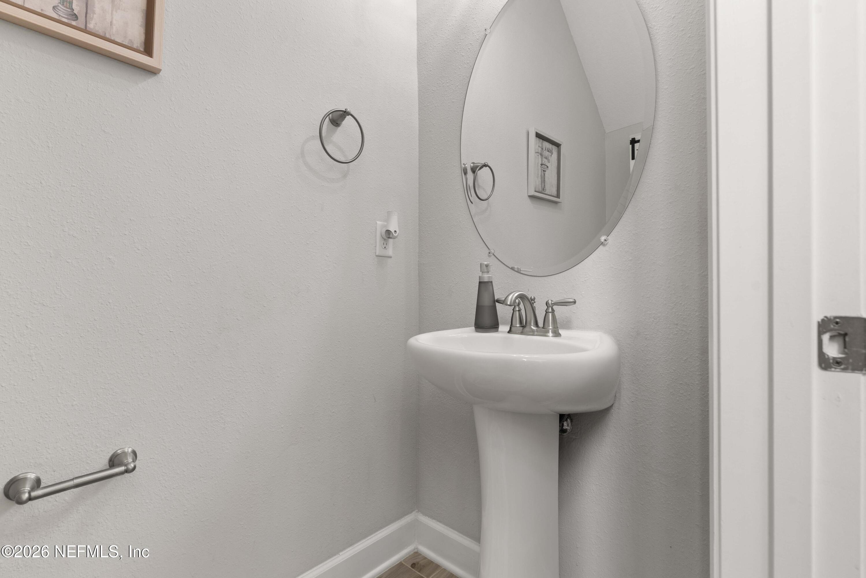 5270 Piney Flats Road Jacksonville, FL 32224 - Photo 23 of 53 a bathroom with a sink and a mirror