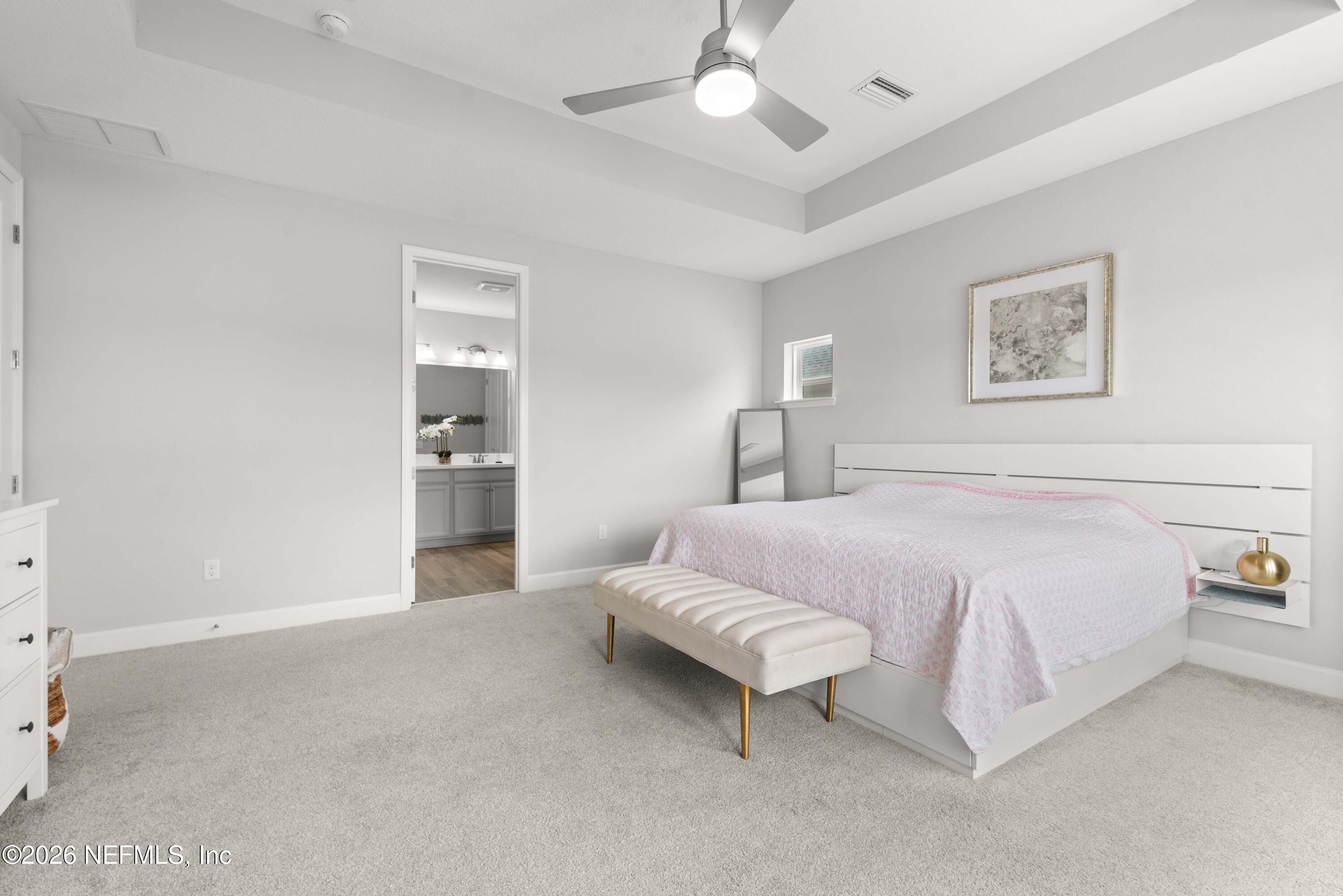 5270 Piney Flats Road Jacksonville, FL 32224 - Photo 29 of 53 a spacious bedroom with a bed and a chandelier