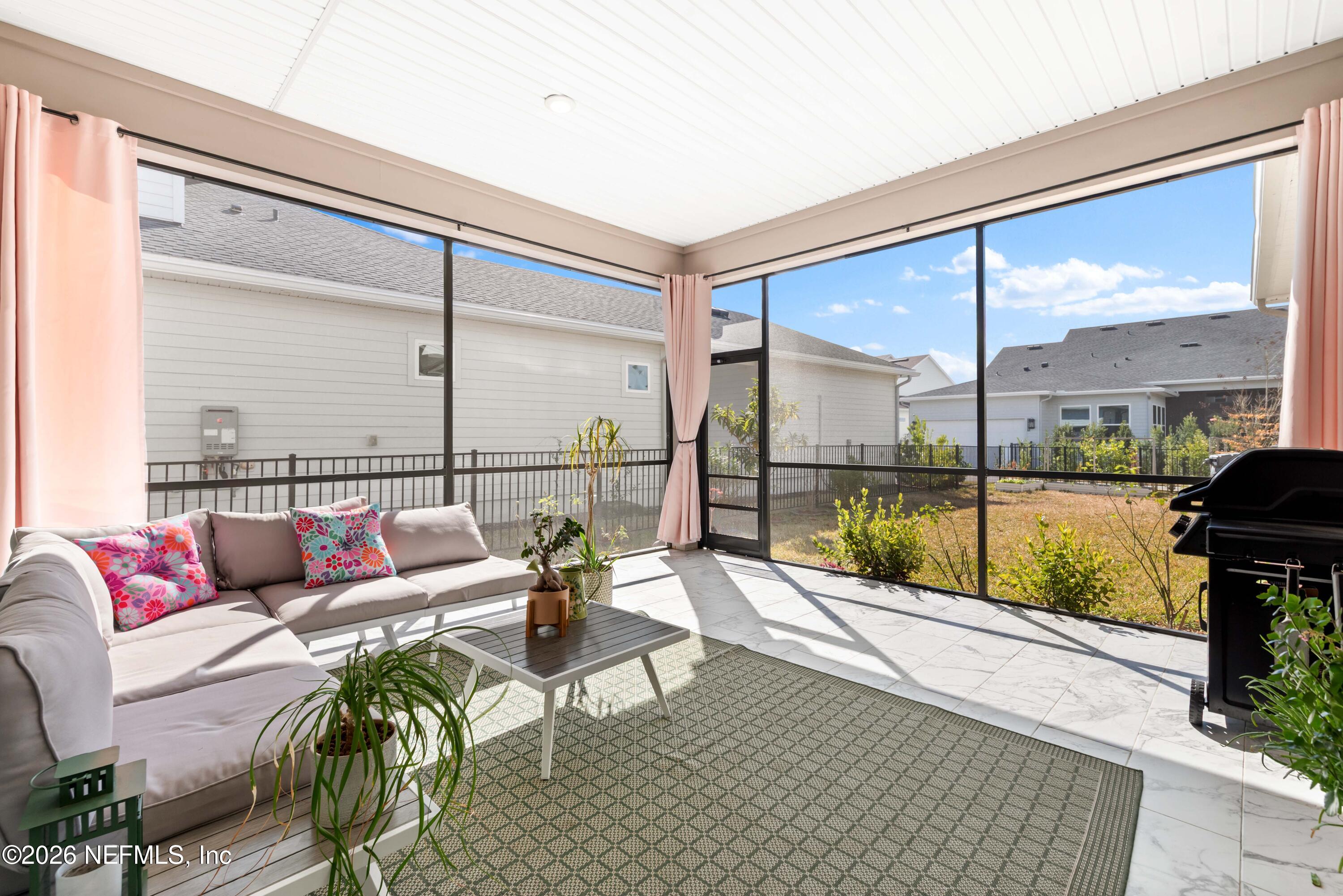 5270 Piney Flats Road Jacksonville, FL 32224 - Photo 40 of 53 a living room with furniture and a floor to ceiling window
