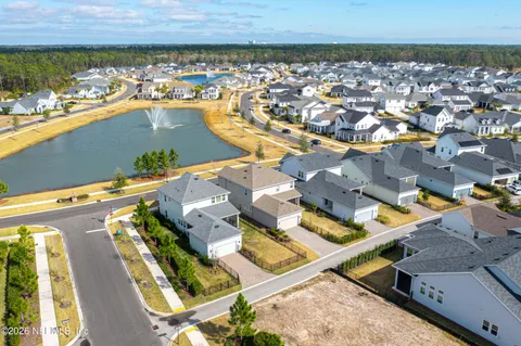 a view of a house with a patio and a yard