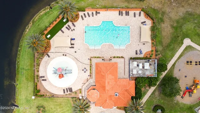 an aerial view of a house with a swimming pool