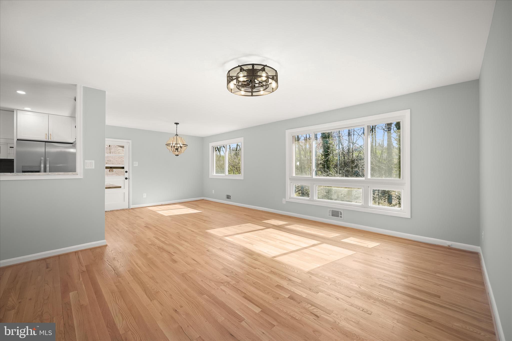 9720 Hedin Drive Silver Spring, MD 20903 - Photo 29 of 79 a view of an empty room with a window and wooden floor