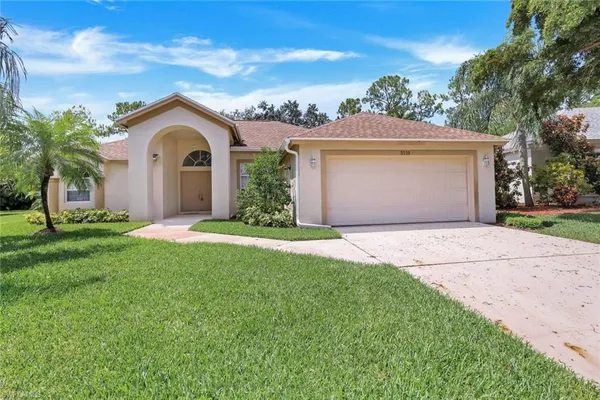 a front view of a house with a yard and garage