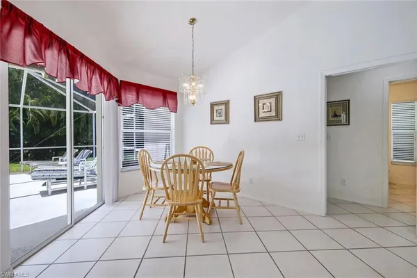 a dining room with furniture and large windows