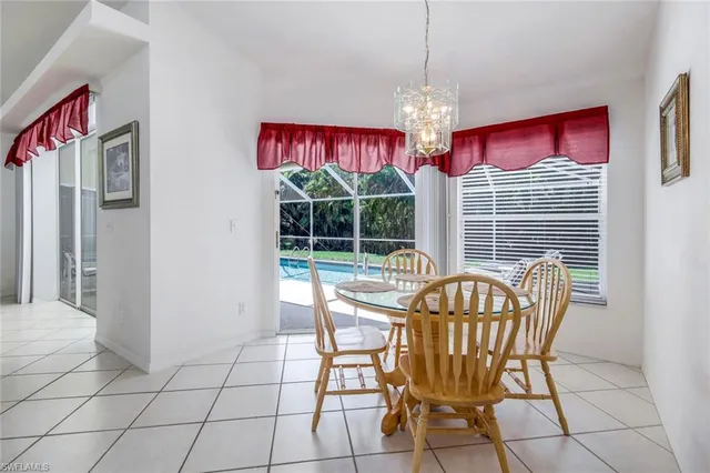 a view of a dining room with furniture large windows and wooden floor