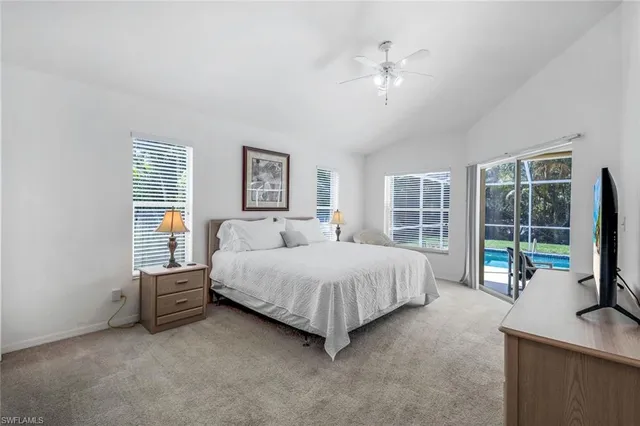 a spacious bedroom with a bed and a large window