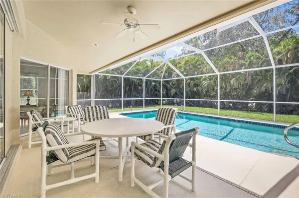 a view of a chair and table in the backyard