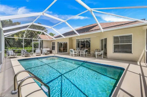 a view of swimming pool with outdoor seating