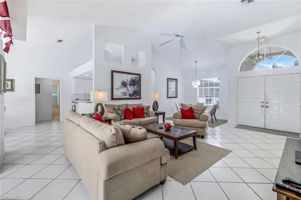 a living room with furniture and a chandelier