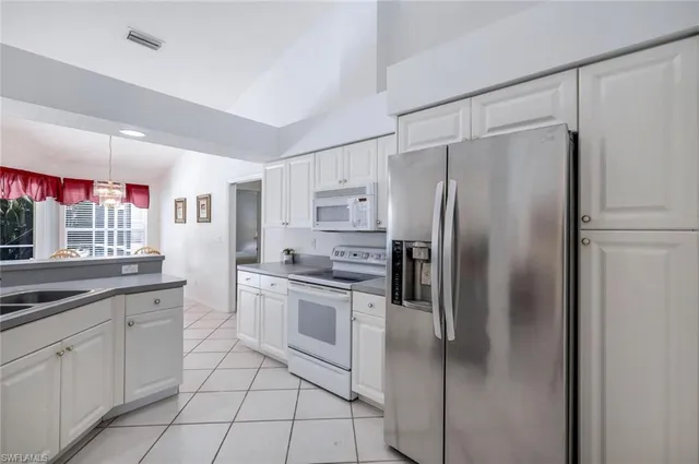 a kitchen with cabinets stainless steel appliances and a counter space