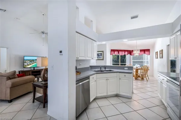 a kitchen with stainless steel appliances granite countertop a sink and cabinets