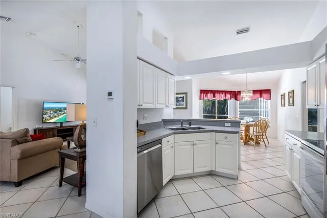 a kitchen with stainless steel appliances granite countertop a sink and cabinets
