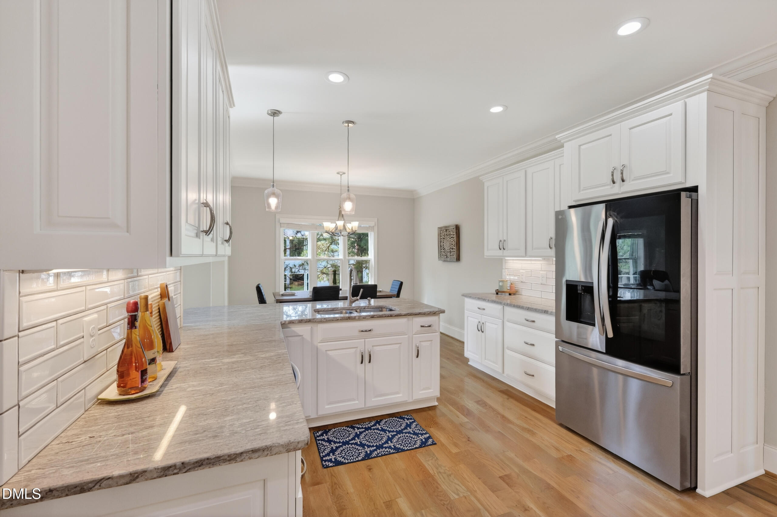 261 Character Drive Rolesville, NC 27571 - Photo 22 of 77 a kitchen with stainless steel appliances kitchen island granite countertop a stove a sink and a refrigerator
