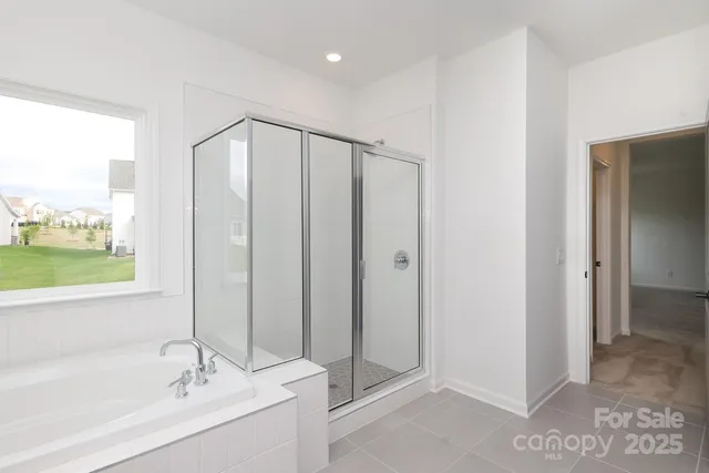 a bathroom with a bathtub and a shower