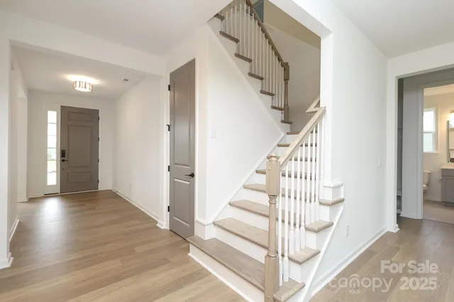 a view of entryway and hall with wooden floor