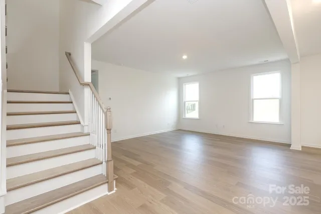 a view of entryway with wooden floor and stairs
