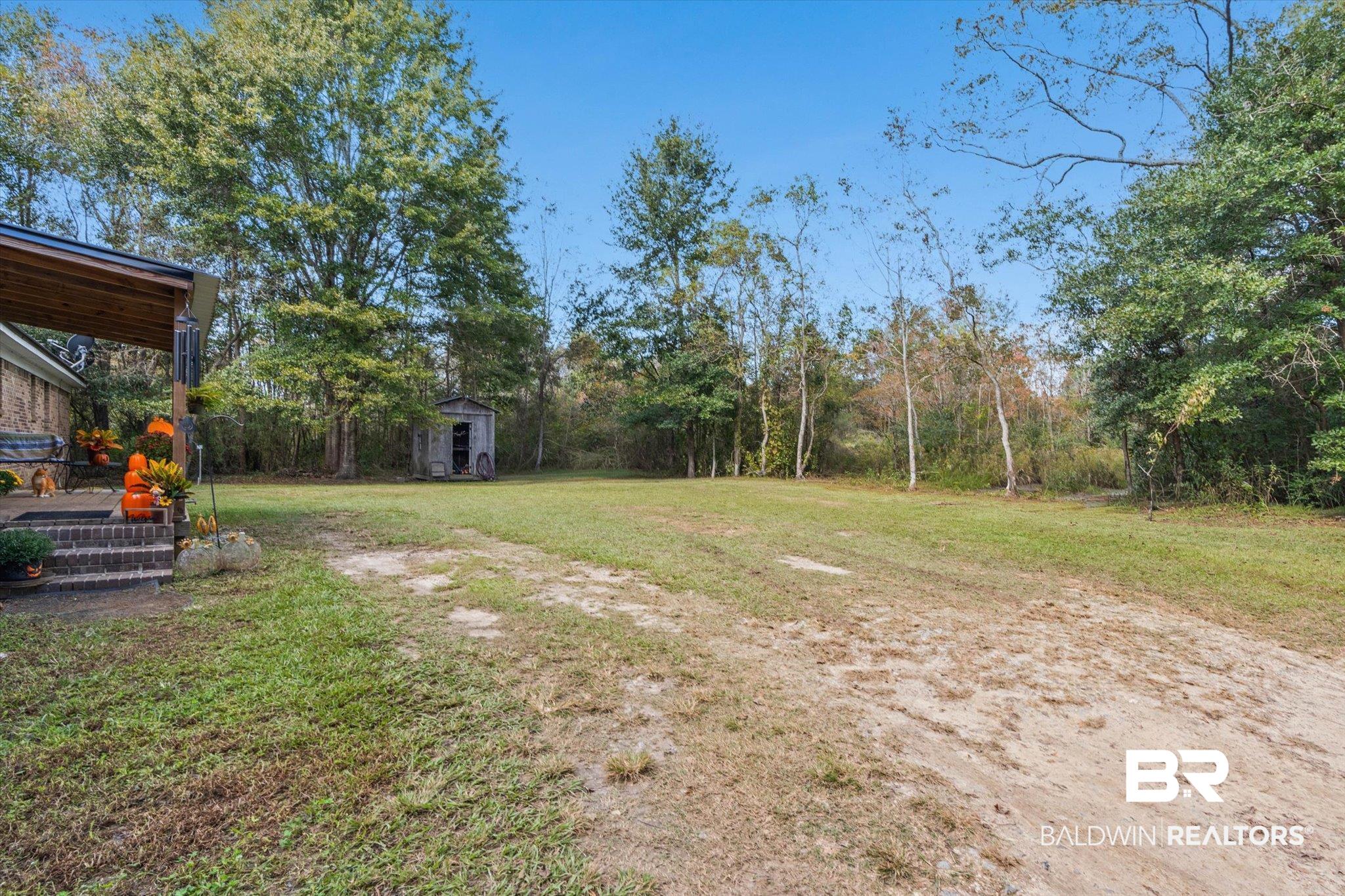 11440 Diffee Road Grand Bay, AL 36541 - Photo 21 of 22 View of green lawn featuring a shed