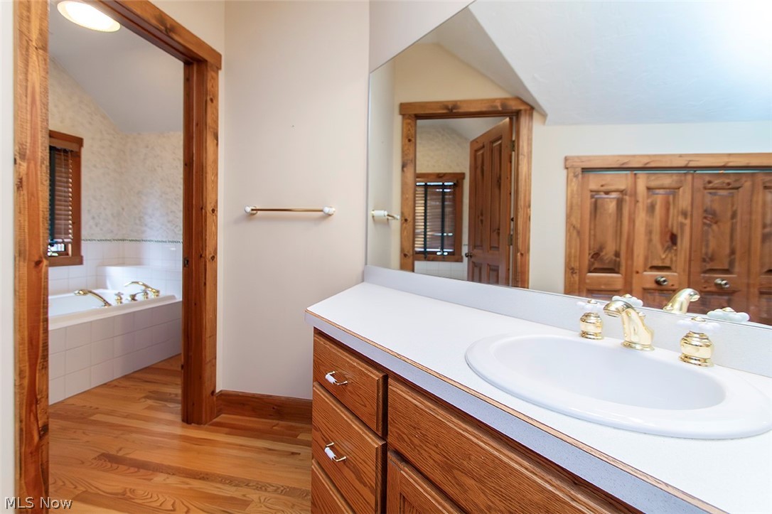 1871 Mattingly Road Hinckley, OH 44233 - Photo 34 of 50 Full bathroom with lofted ceiling, light wood-type flooring, vanity, and a bath
