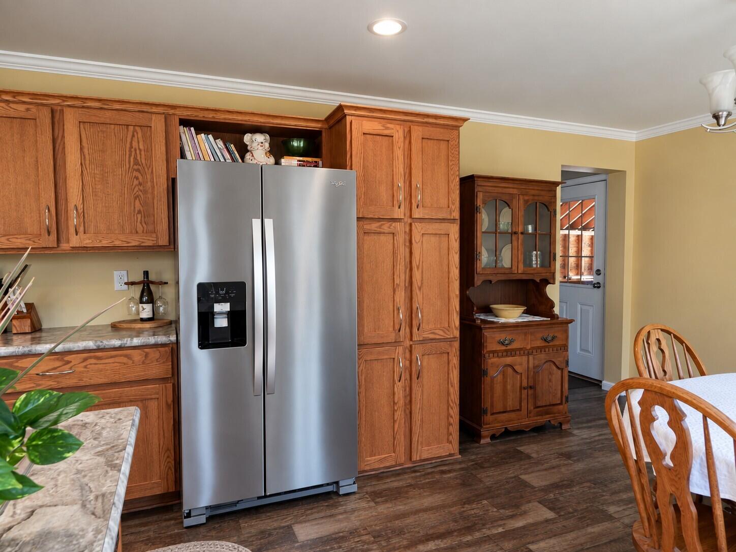 338 Marshfield Flats Road Marshfield, ME 04654 - Photo 9 of 26 Warmly Lit Oak Kitchen Dining Area