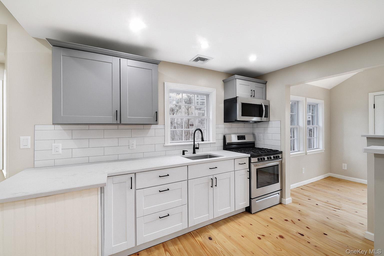 80 Kitz Road Monticello, NY 12701 - Photo 11 of 39 a kitchen with a sink stove and microwave