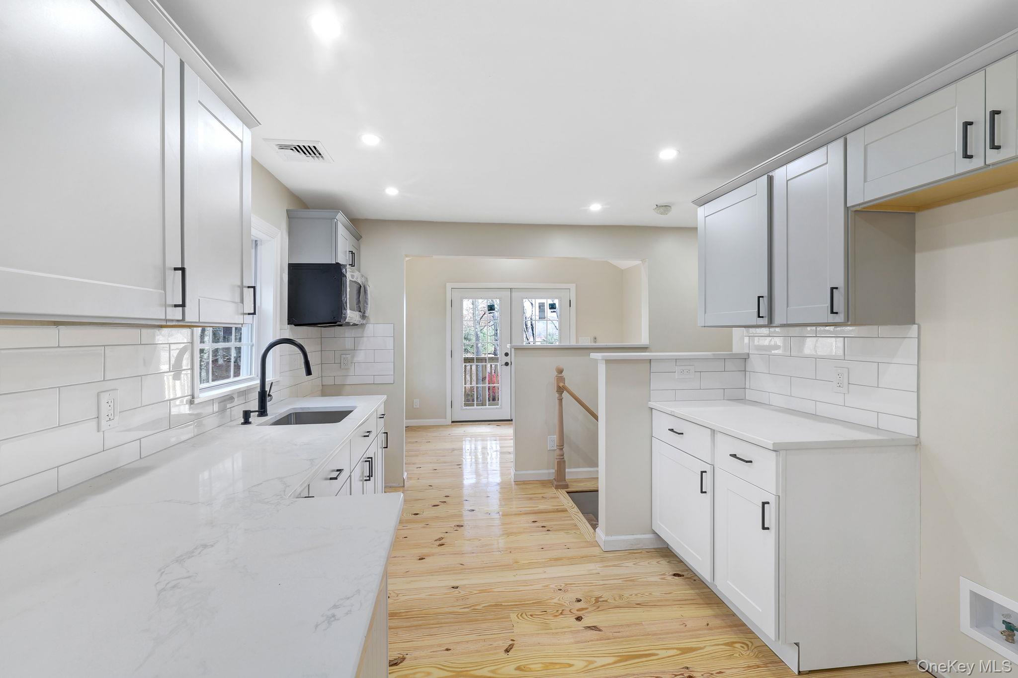 80 Kitz Road Monticello, NY 12701 - Photo 12 of 39 a large kitchen with stainless steel appliances kitchen island granite countertop a sink and cabinets