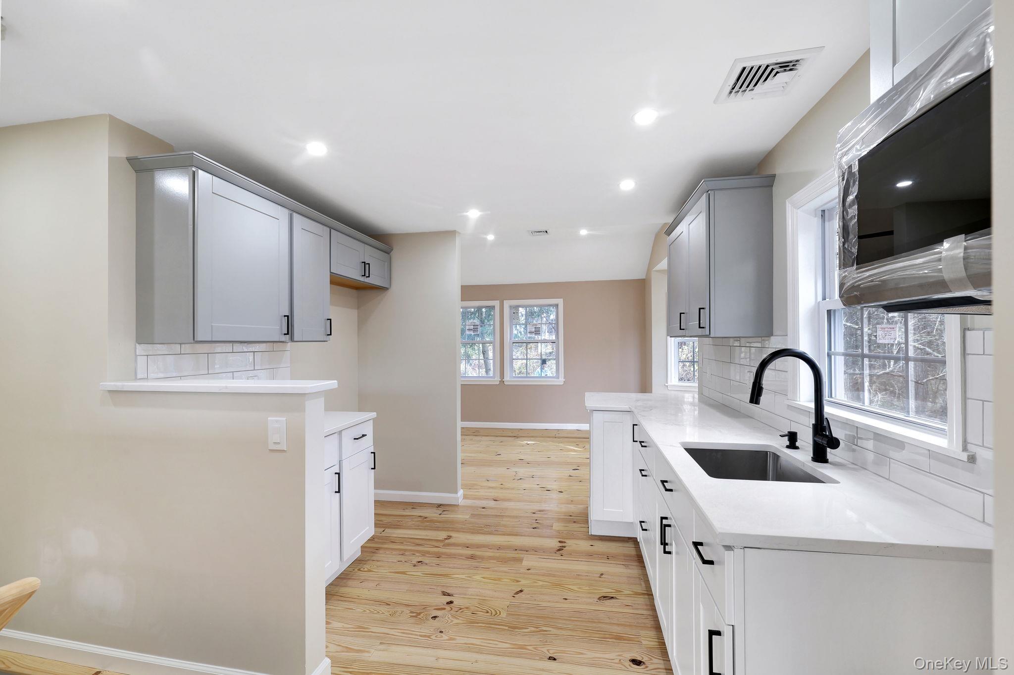80 Kitz Road Monticello, NY 12701 - Photo 13 of 39 a kitchen with stainless steel appliances a sink a stove and cabinets