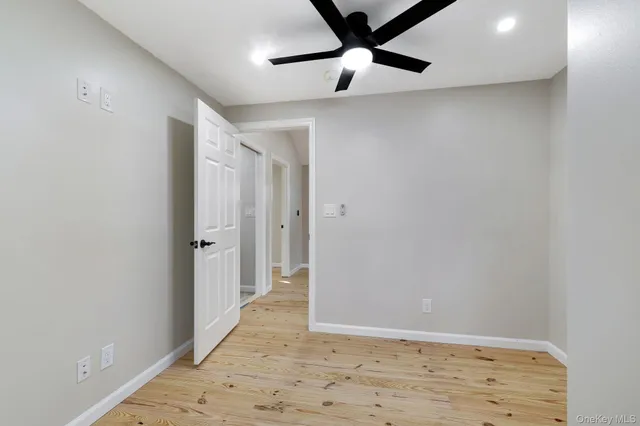 a bathroom with a bathtub shower sink mirror and toilet