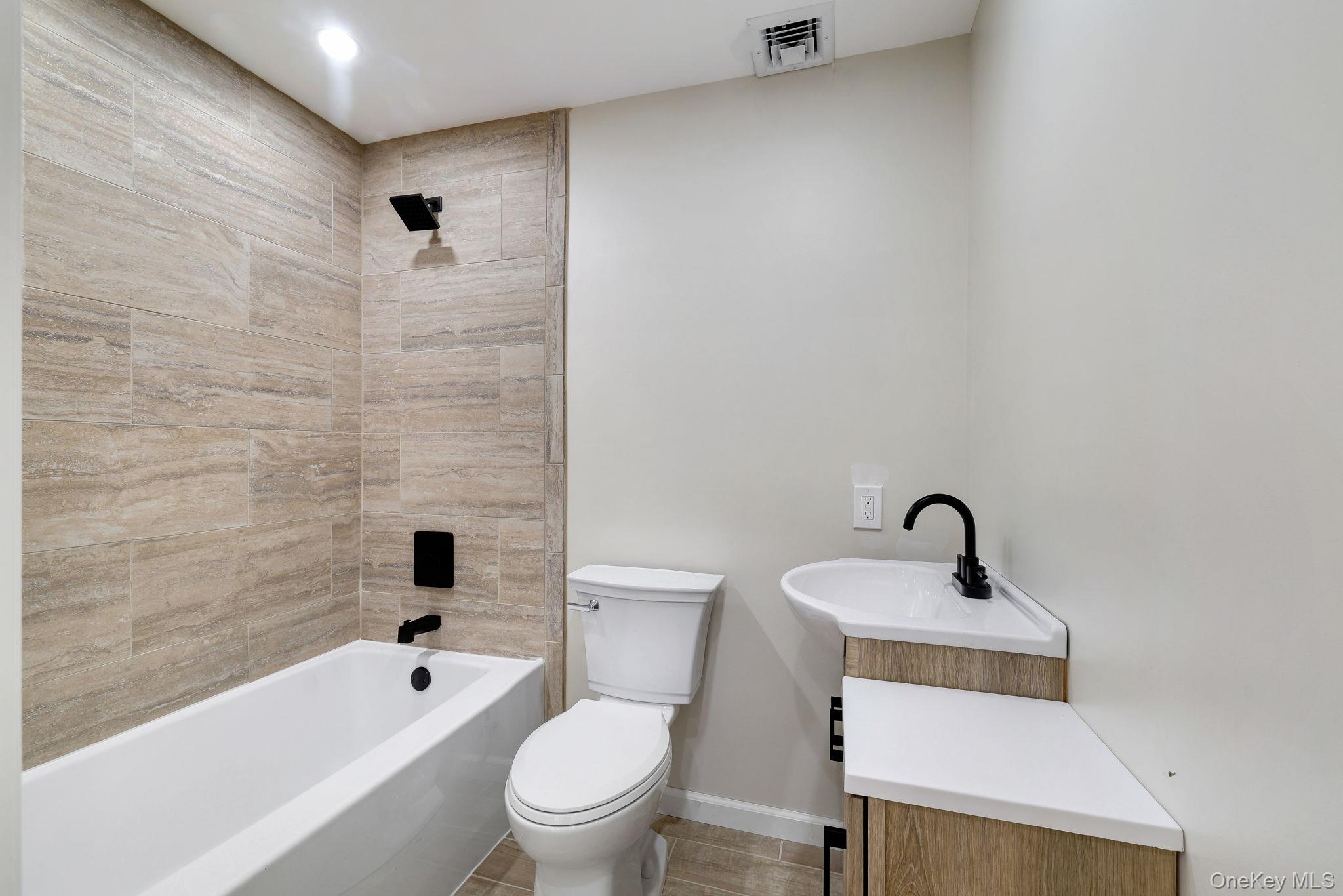 80 Kitz Road Monticello, NY 12701 - Photo 19 of 39 a bathroom with a bathtub shower sink mirror and toilet