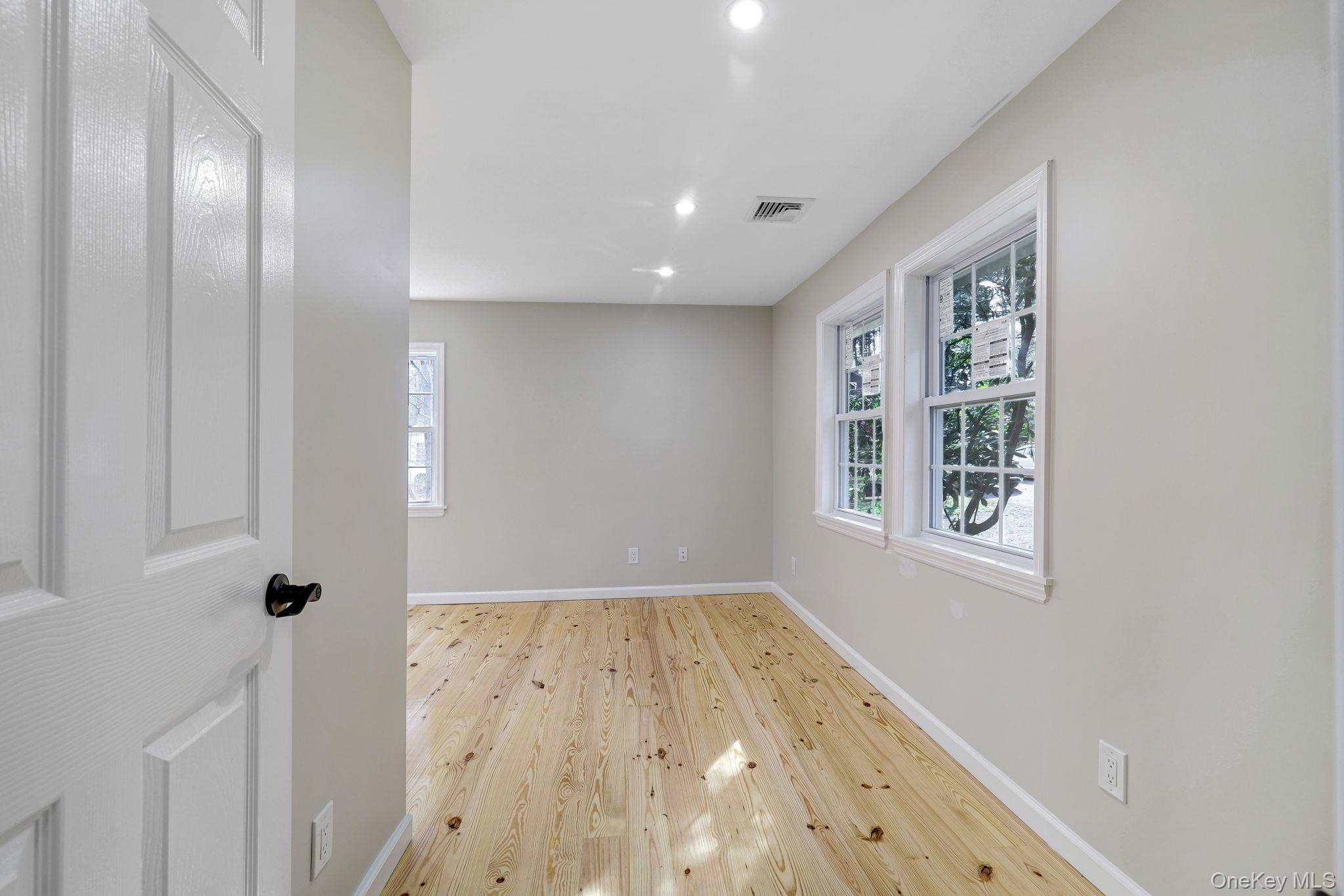 80 Kitz Road Monticello, NY 12701 - Photo 20 of 39 an empty room with wooden floor and windows