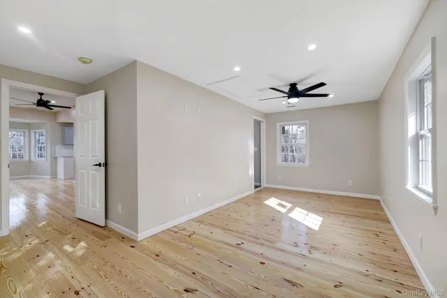 a view of empty room with wooden floor