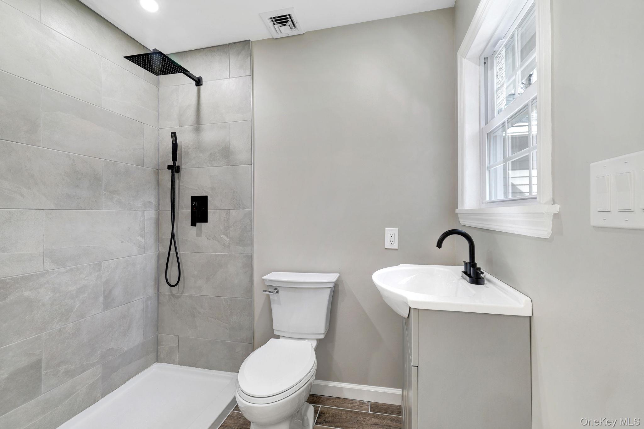 80 Kitz Road Monticello, NY 12701 - Photo 23 of 39 a bathroom with a toilet sink shower and mirror