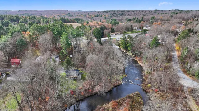 a front view of a house with a yard table and chairs