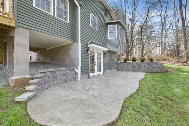 a front view of a house with a garden and trees