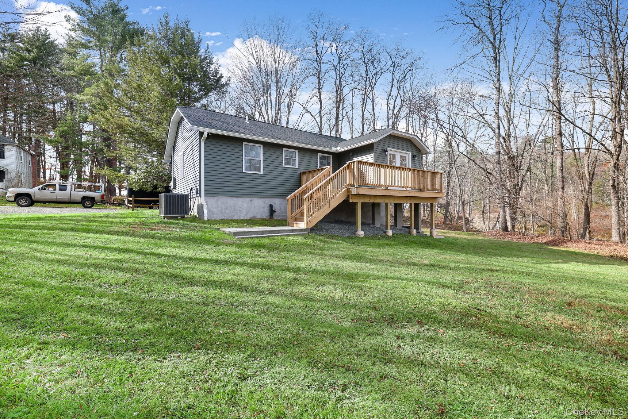 80 Kitz Road Monticello, NY 12701 - Photo 35 of 39 a front view of a house with a garden and trees