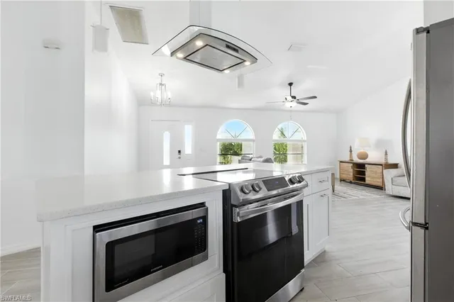 a kitchen with stainless steel appliances granite countertop a stove and a sink