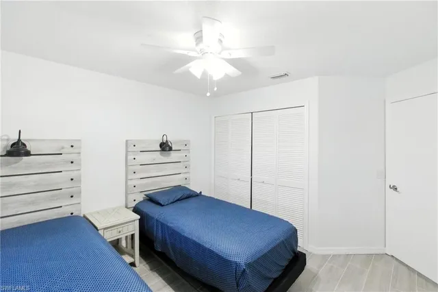a bedroom with a bed and cabinets