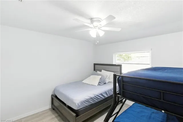 a bedroom with a bed and window