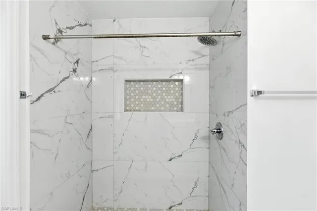 a bathroom with a shower and a shower