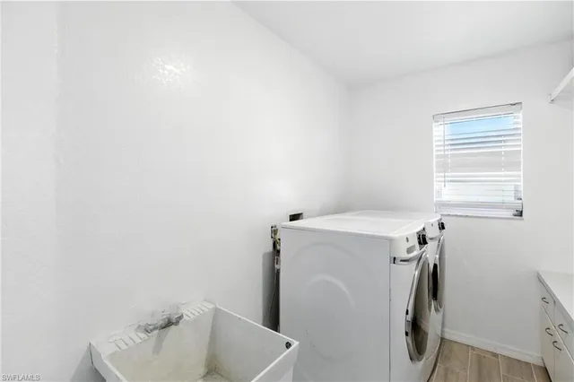 a bathroom with a sink and a washer dryer