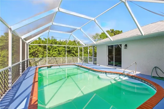 a view of a backyard with swimming pool