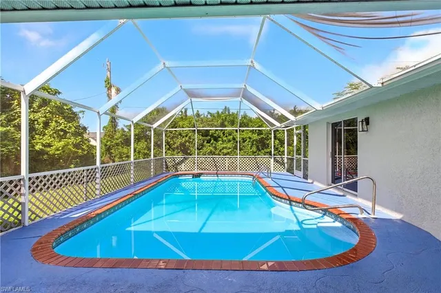 a view of a swimming pool with an outdoor space and seating area