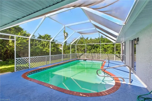 a view of a room with wooden floor and pool table