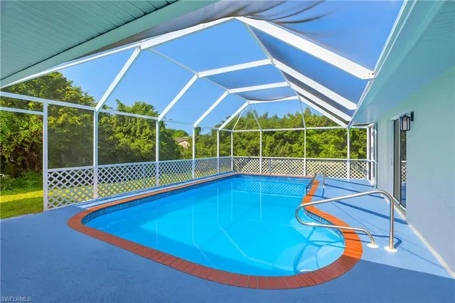 a view of a backyard with a swimming pool