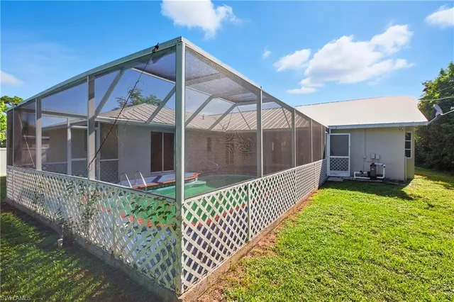 a view of a house with wooden fence