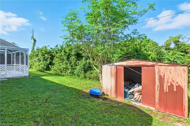 a view of backyard with tub and trees
