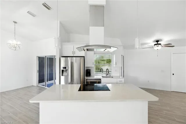 a room with a chandelier and wooden floor