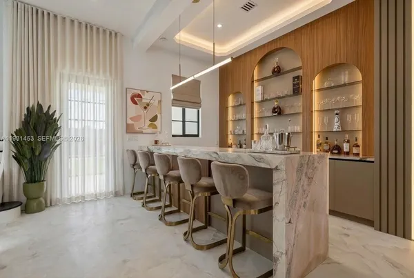 a view of a kitchen with refrigerator and a living room